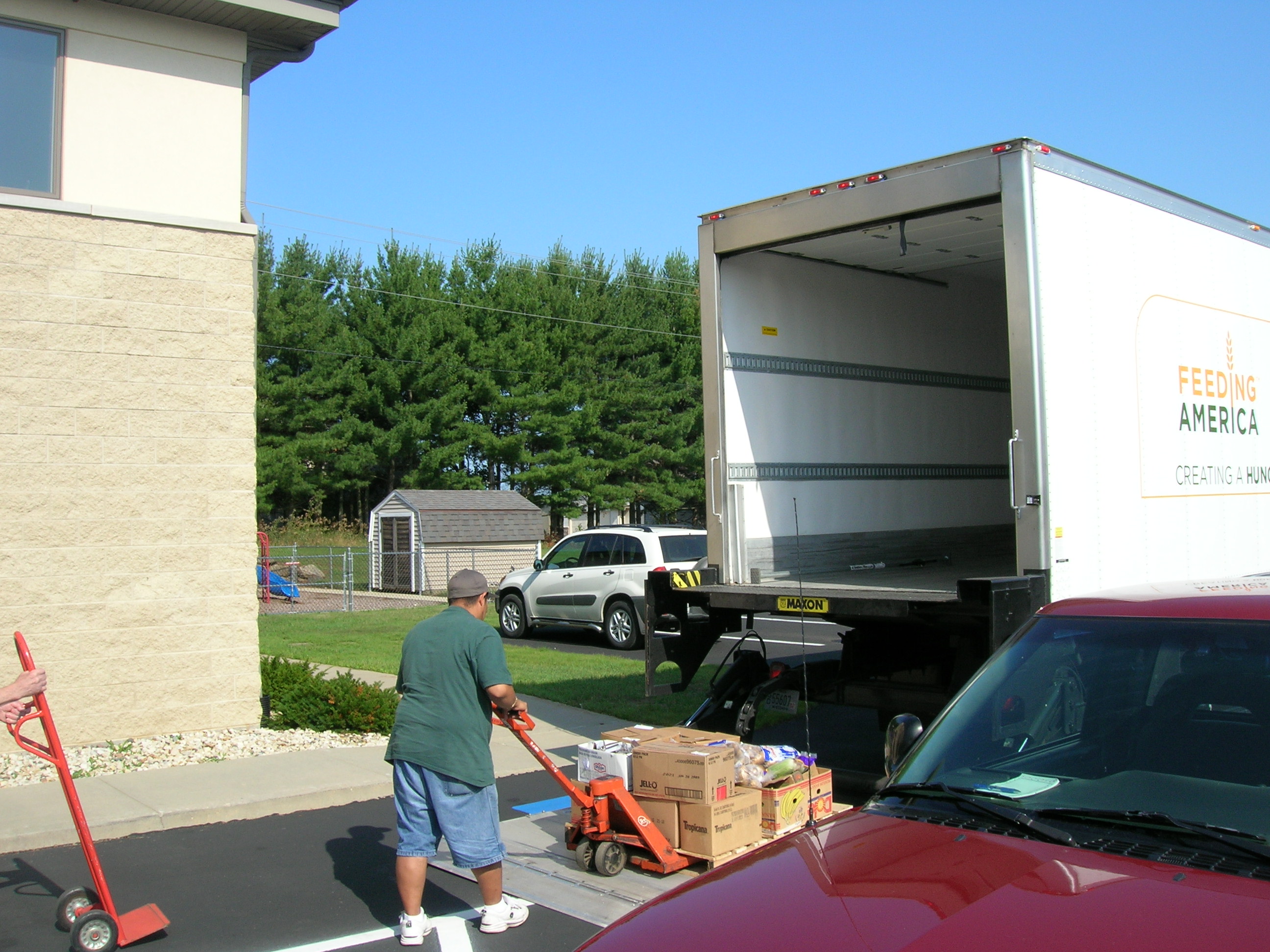 Food pantry volunteer unloads a Second Harvest truck